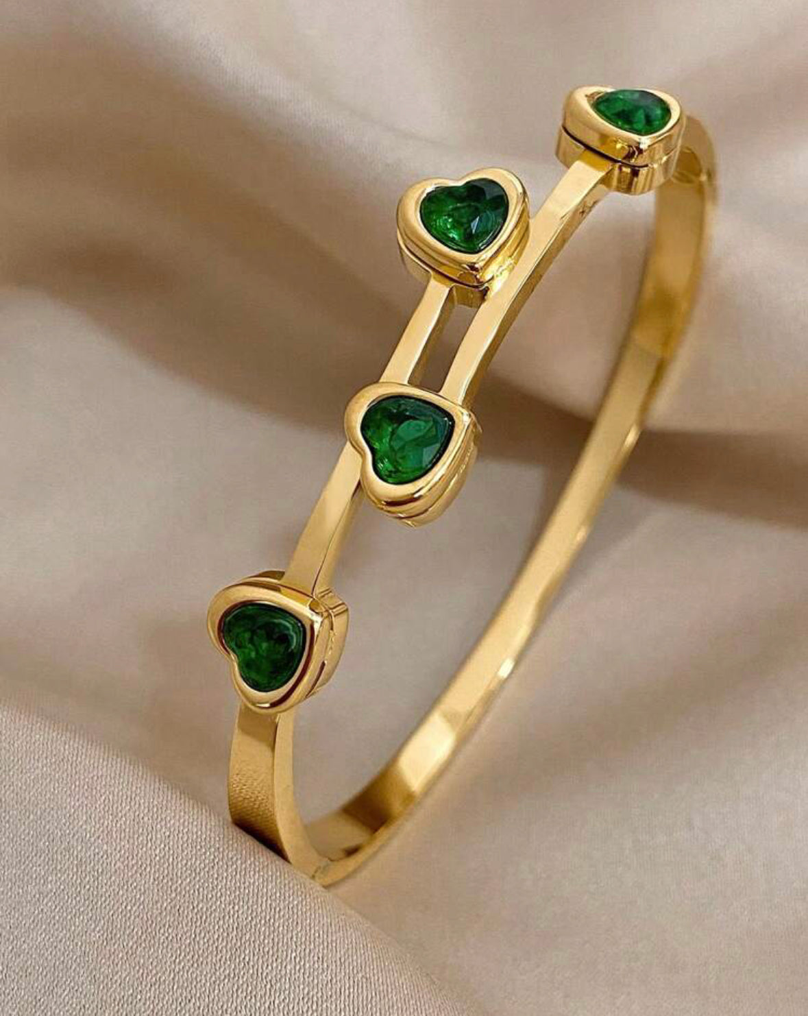 Green cubic zirconia heart bracelet.