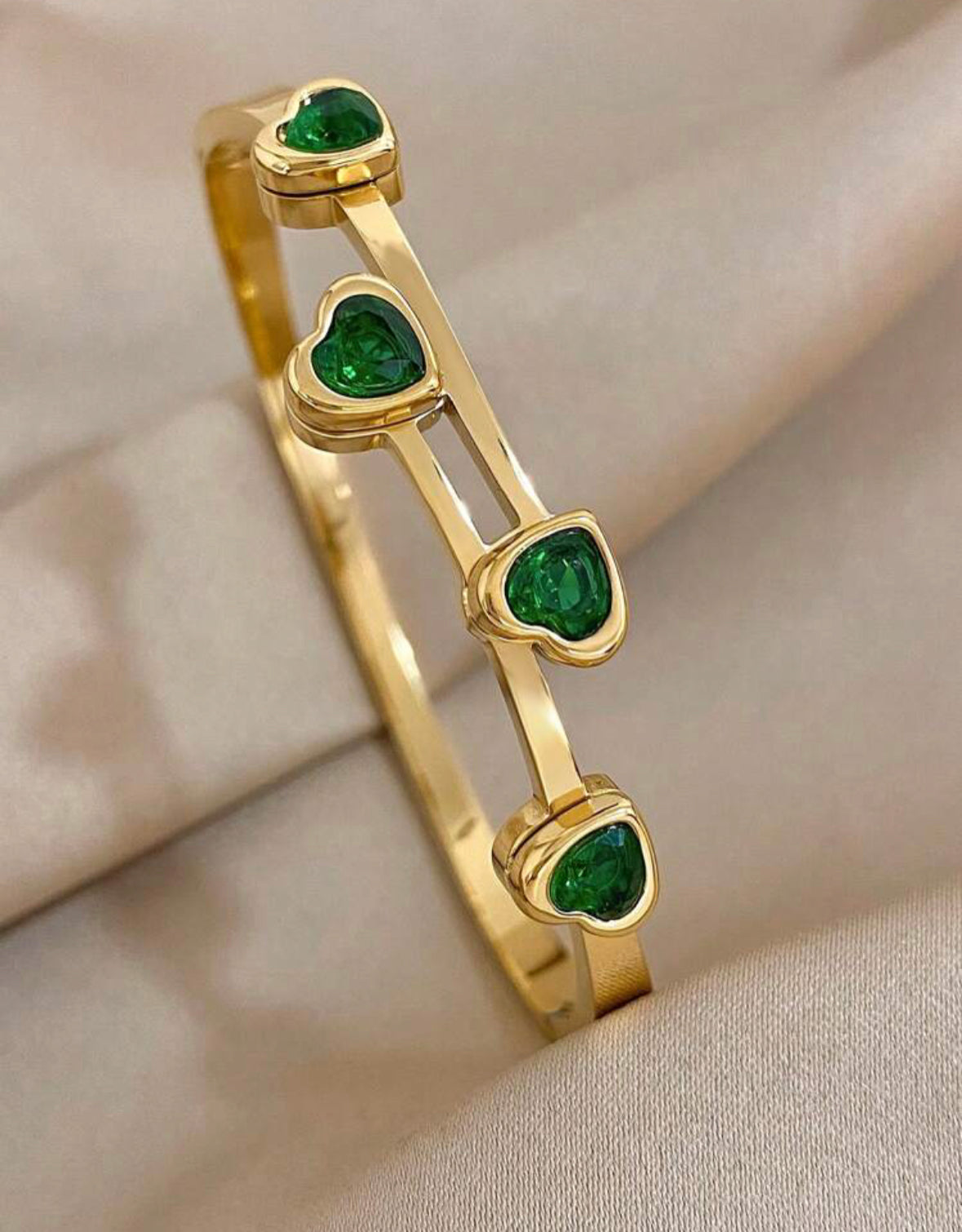 Green cubic zirconia heart bracelet.