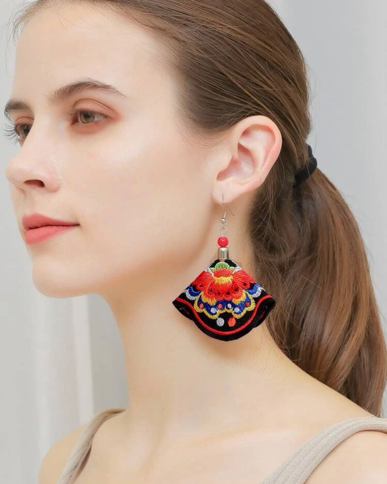 Flower embroidered drop earrings.