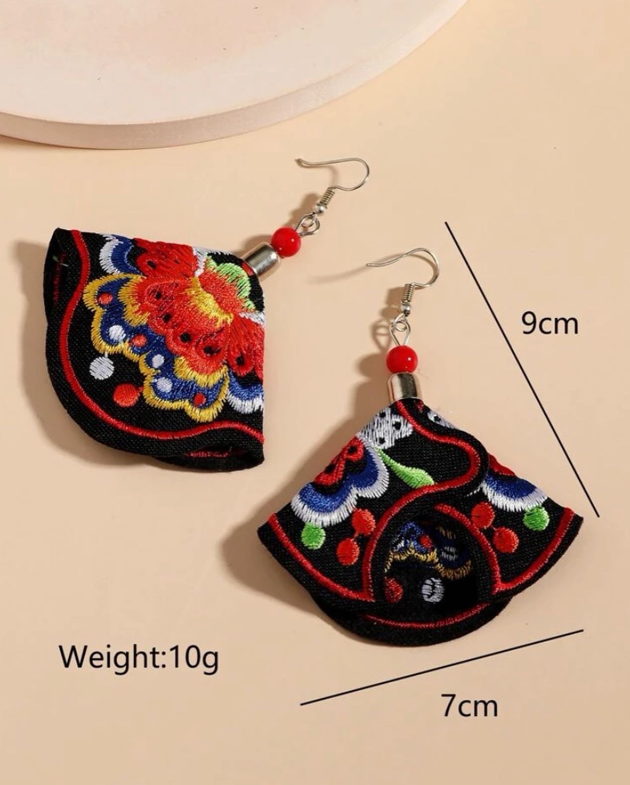 Flower embroidered drop earrings.