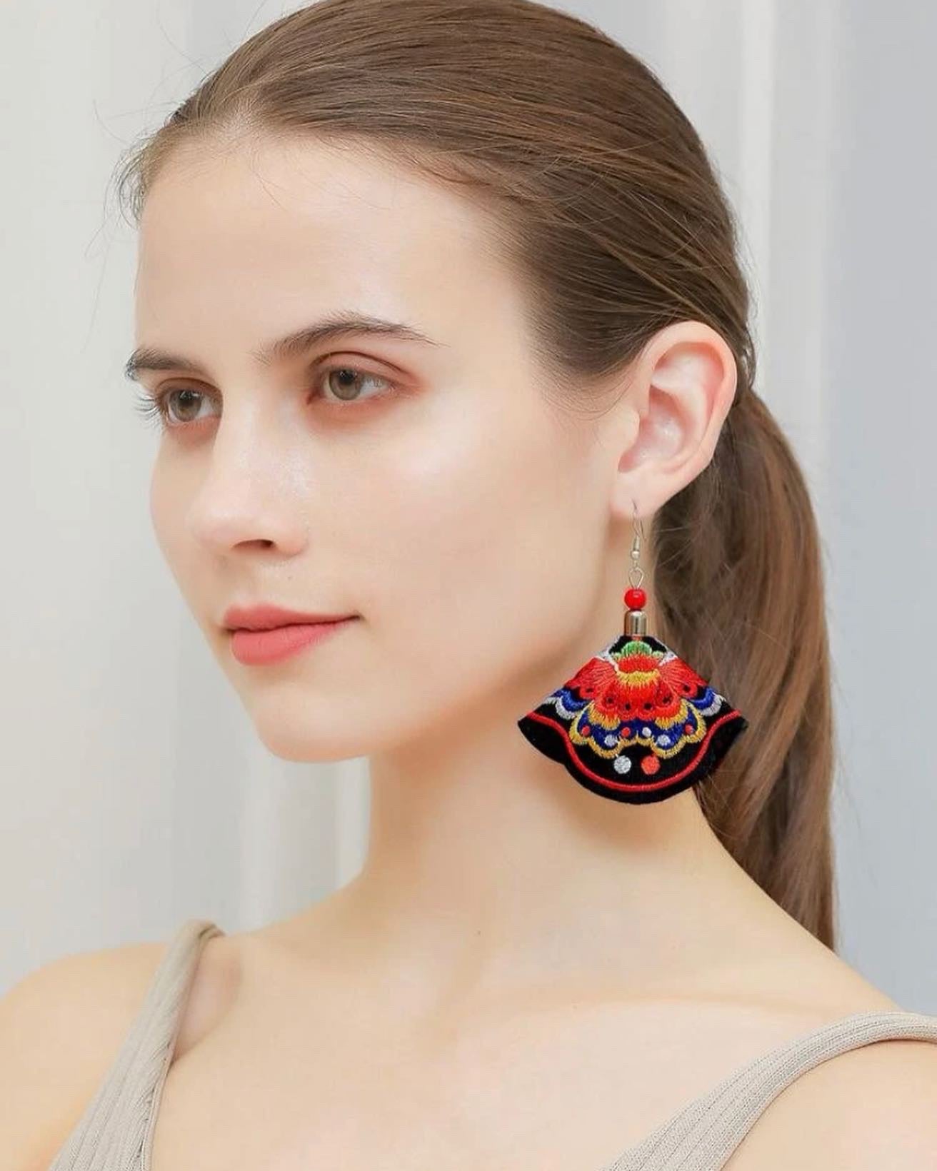 Flower embroidered drop earrings.