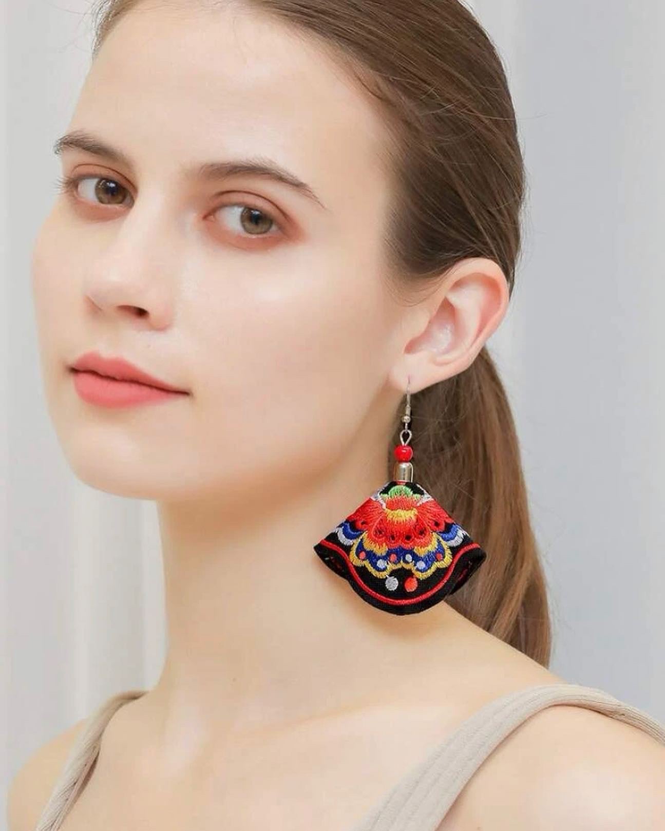Flower embroidered drop earrings.